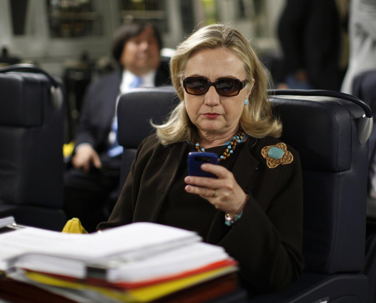 Hillary Rodham Clinton uses her BlackBerry in October 2011, while she was secretary of State.