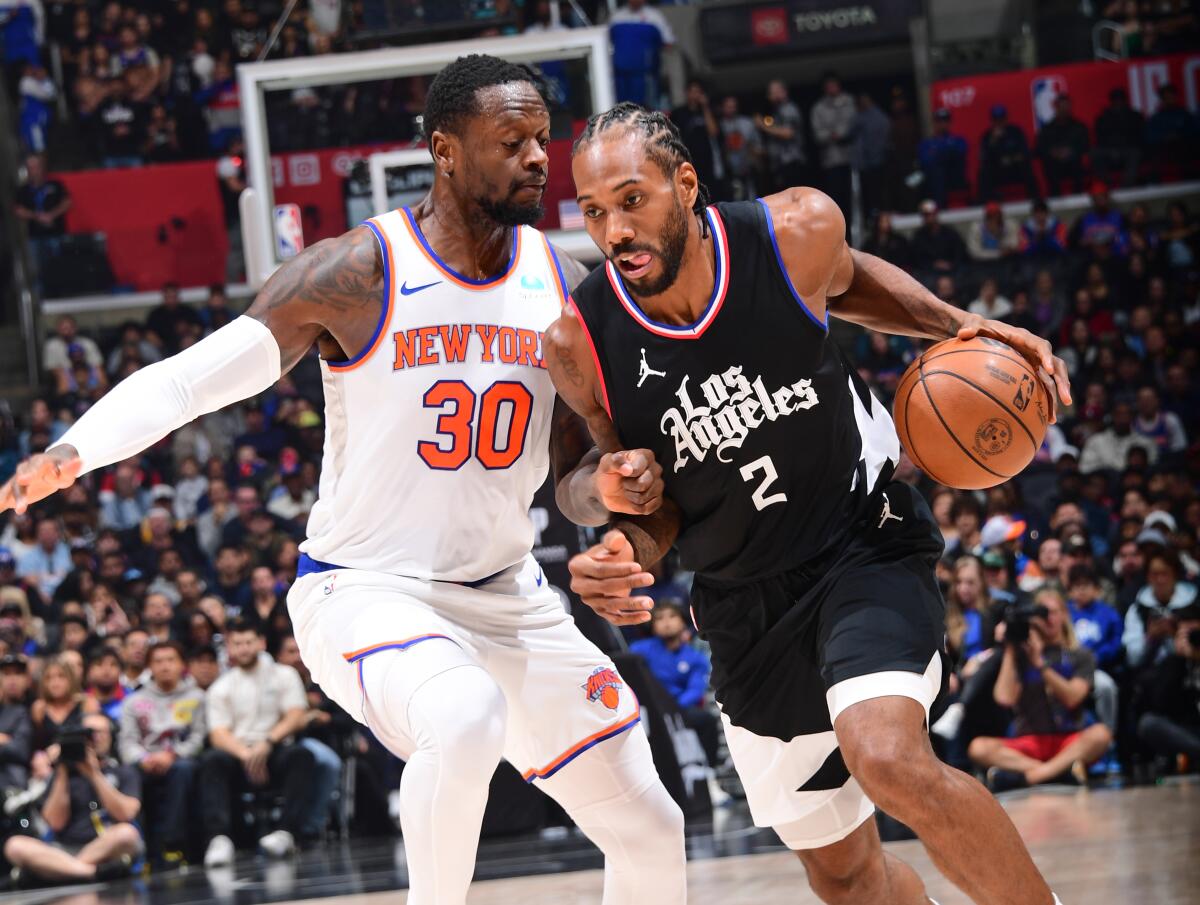Clippers star Kawhi Leonard tries to drive past New York Knicks forward Julius Randle at Crypto.com Arena.