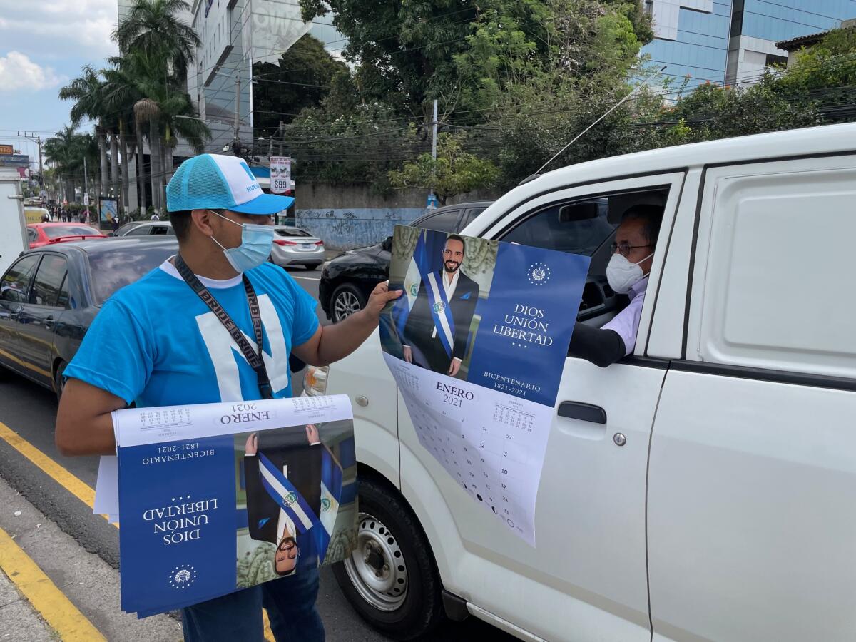 A man hands political literature to a motorist