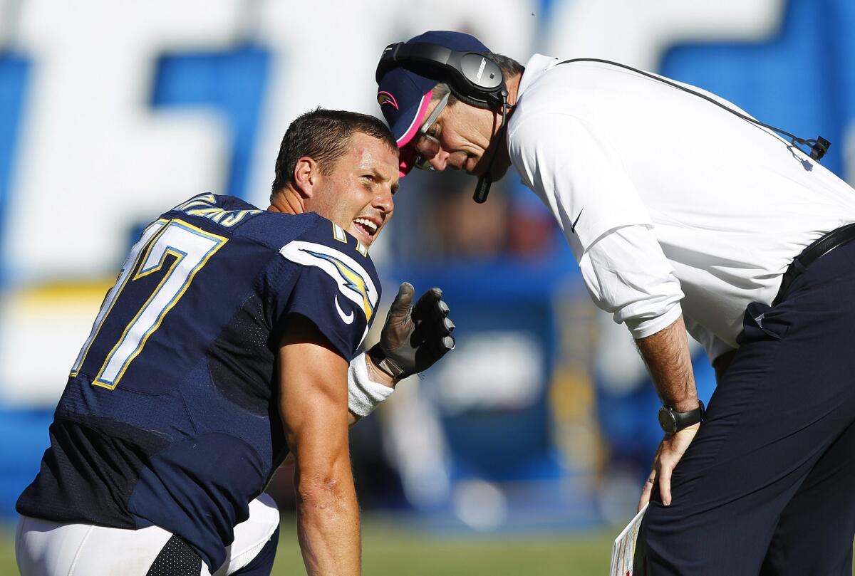 Philip Rivers and Frank Reich talk during a game against the New York Jets.