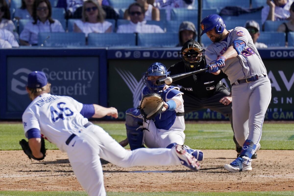 New York Mets batter J.D. Davis, right, hits a run-scoring double off Dodgers closer Craig Kimbrel during the 10th inning.