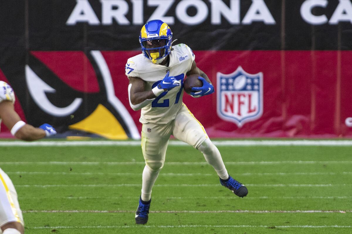Rams running back Darrell Henderson (27) carries the football against  the Arizona Cardinals in December.