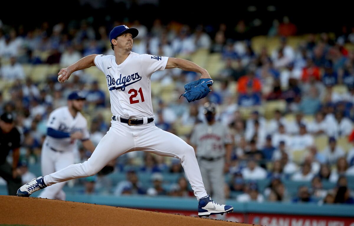 Dodgers pitcher Walker Buehler delivers a pitch against the Houston Astros in the first inning at Dodger Stadium on Tuesday.