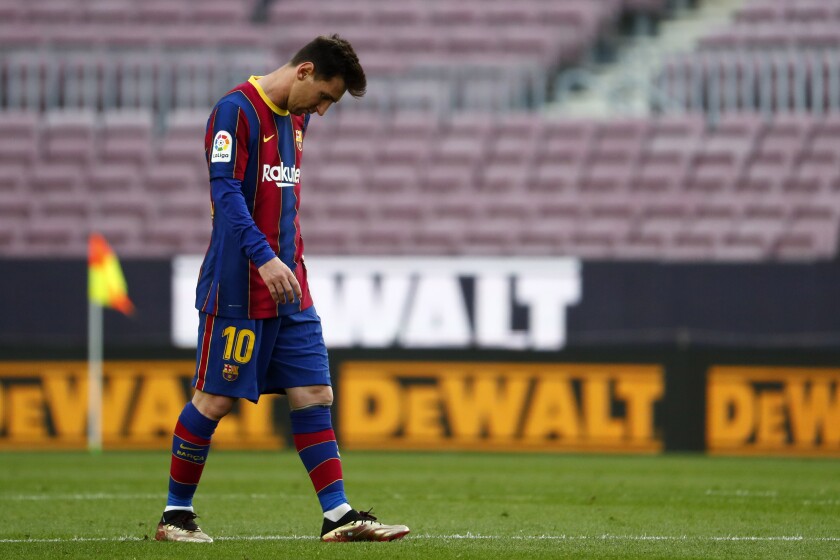 Barcelona's Lionel Messi walks during the Spanish La Liga soccer match between FC Barcelona and Celta at the Camp Nou stadium in Barcelona, Spain, Sunday, May. 16, 2021. (AP Photo/Joan Monfort)