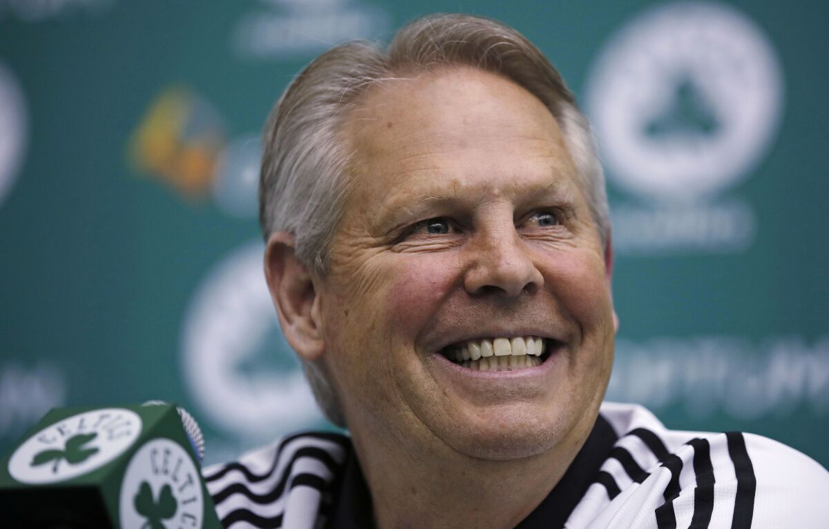 Danny Ainge, Boston Celtics president of basketball operations, smiles as he addresses reporters at the team's training facility in Waltham, Mass., on May 16, 2017. Ainge, who helped the Celtics win two NBA titles as a player and another as a team executive, is the new CEO of the Utah Jazz, the team announced Wednesday, Dec. 15, 2021. (AP Photo/Charles Krupa, File)