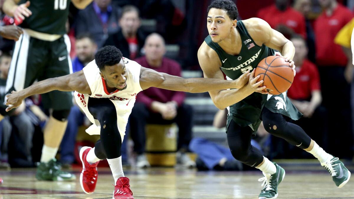 Michigan State guard Bryn Forbes tries to protect the ball from the reach of Rutgers guard Omari Grier during the first half Wednesday.