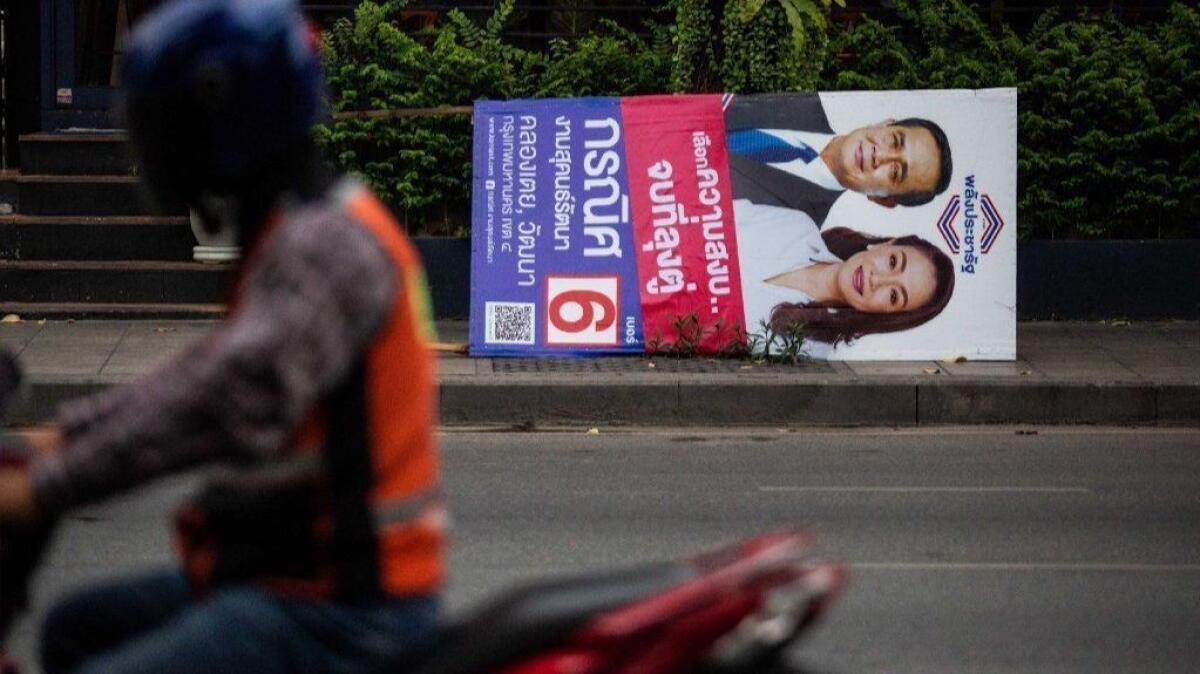 A poster featuring Thai junta leader Prayuth Chan-ocha is taken down in Bangkok after the March 24, 2019, general election.