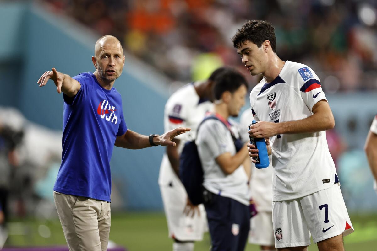 U.S. coach Gregg Berhalter and Gio Reyna during the round of 16 match at the 2022 World Cup against the Netherlands.