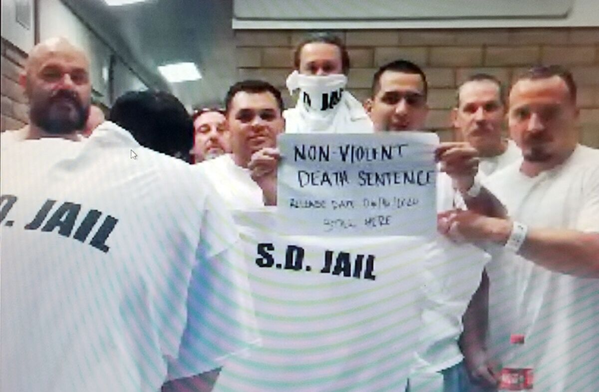 In a screen grab from a video call, inmates at the East Mesa Reentry Facility protest the lack of protection from the coronavirus inside the jail.
