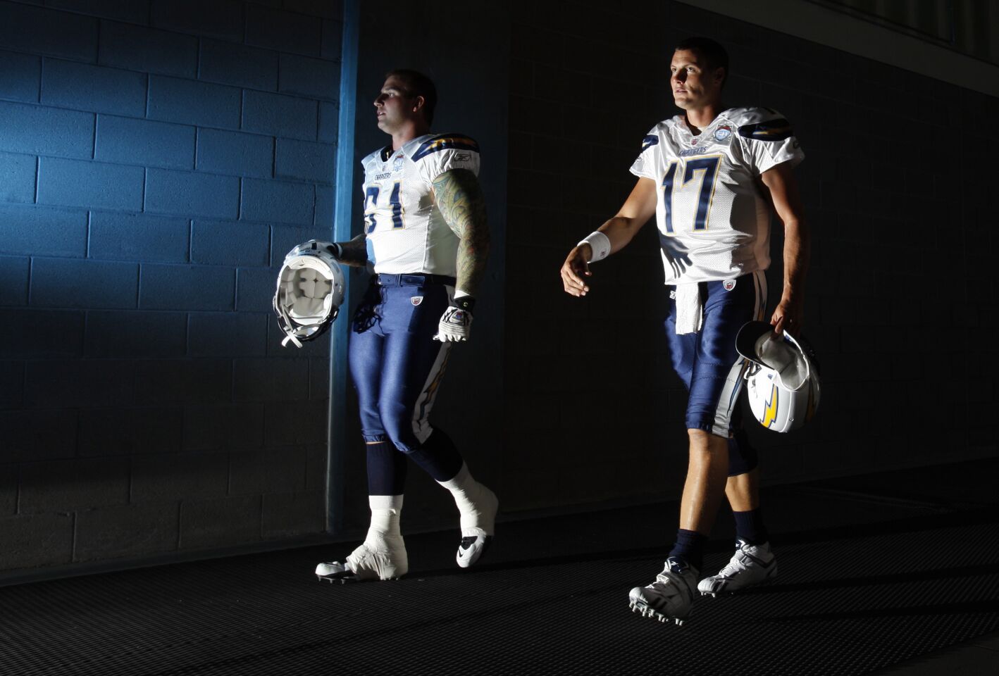 Chargers Nick Hardwick and Philip Rivers walk to the field against the Cardinals in Glendale on Aug. 20, 2009.