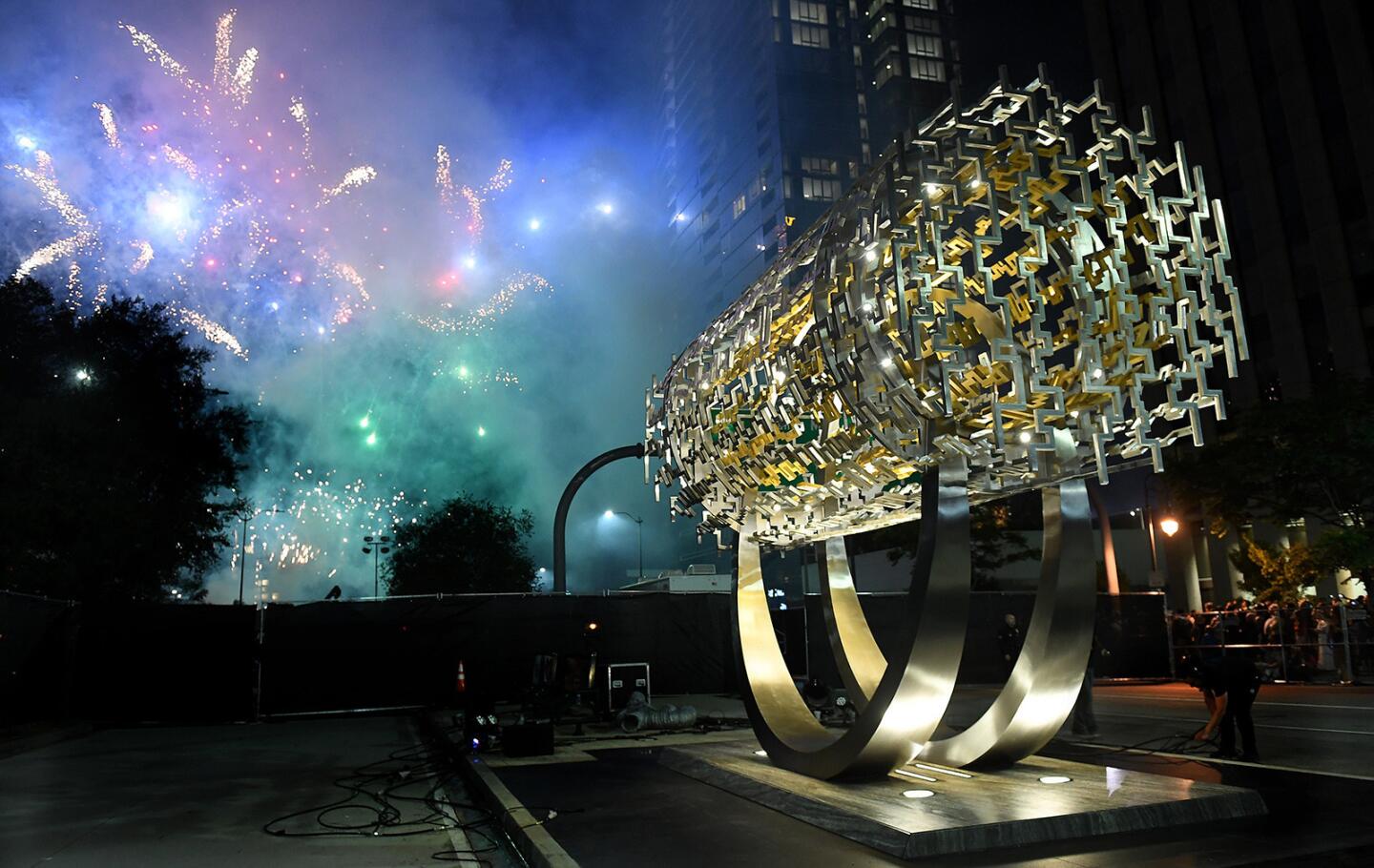 Fireworks are set off behind the Freedom Sculpture during an unveiling Tuesday.