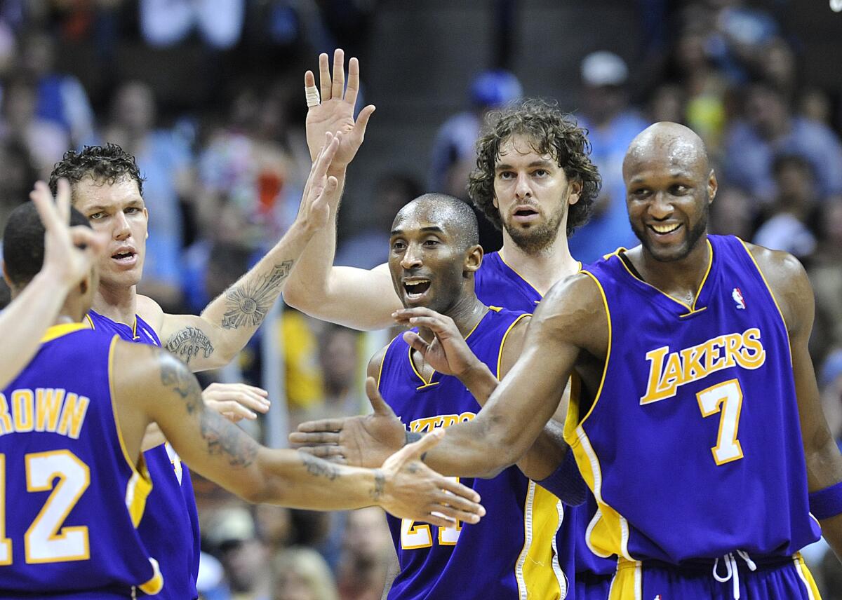Lakers teammates (from right) Lamar Odom, Pau Gasol, Kobe Bryant and Luke Walton congratulate Shannon Brown after he made a key basket against the Nuggets in Game 6 of the Western Conference finals. 