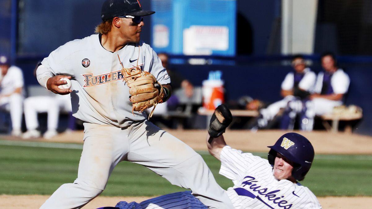 Cal State Fulerton second baseman Hank LoForte looks to turn a double play as Washington's Braiden Ward slides in during the eighth inning Saturday.