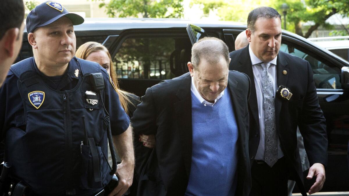 Harvey Weinstein is escorted into court, Friday, May 25, 2018, in New York. Weinstein surrendered Friday to face rape and other charges from encounters with two women.