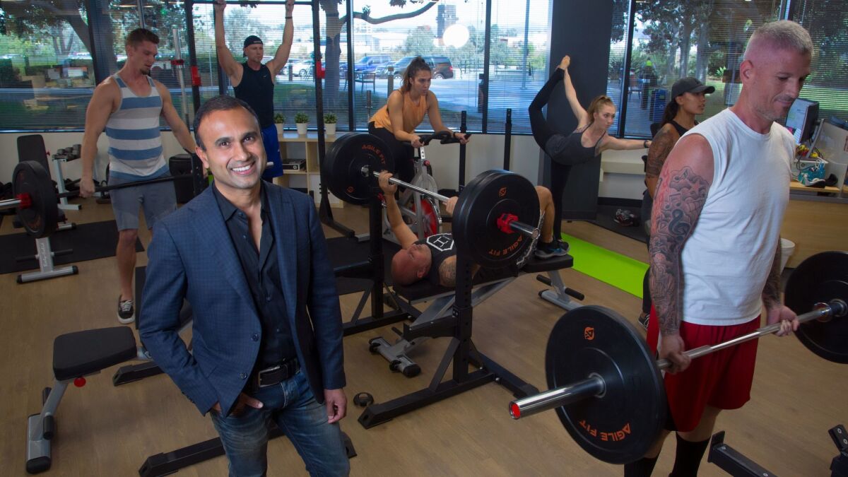 At their office in Kearny Mesa, Munjal Shah, CEO of SD-based Health IQ shows off gym equipment that the company leaves out on the main office floor for employees to exercise during the normal work day.