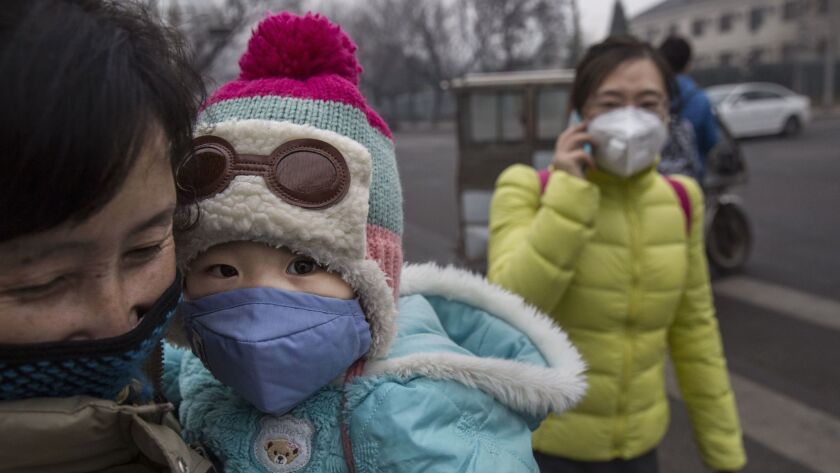 A Chinese girl wears a mask to protect against pollution in Beijing.