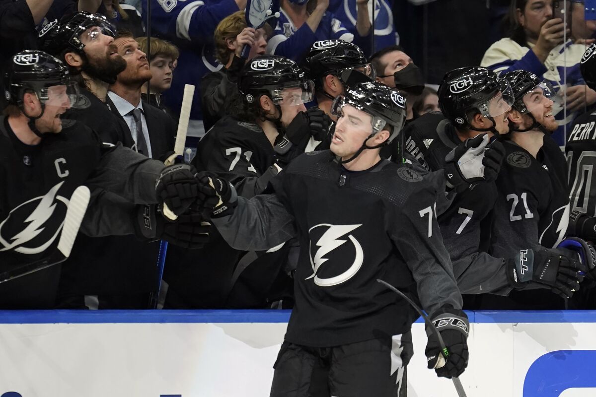 Tampa Bay Lightning center Ross Colton (79) celebrates with the bench after his goal against the Dallas Stars during the third period of an NHL hockey game Saturday, Jan. 15, 2022, in Tampa, Fla. (AP Photo/Chris O'Meara)
