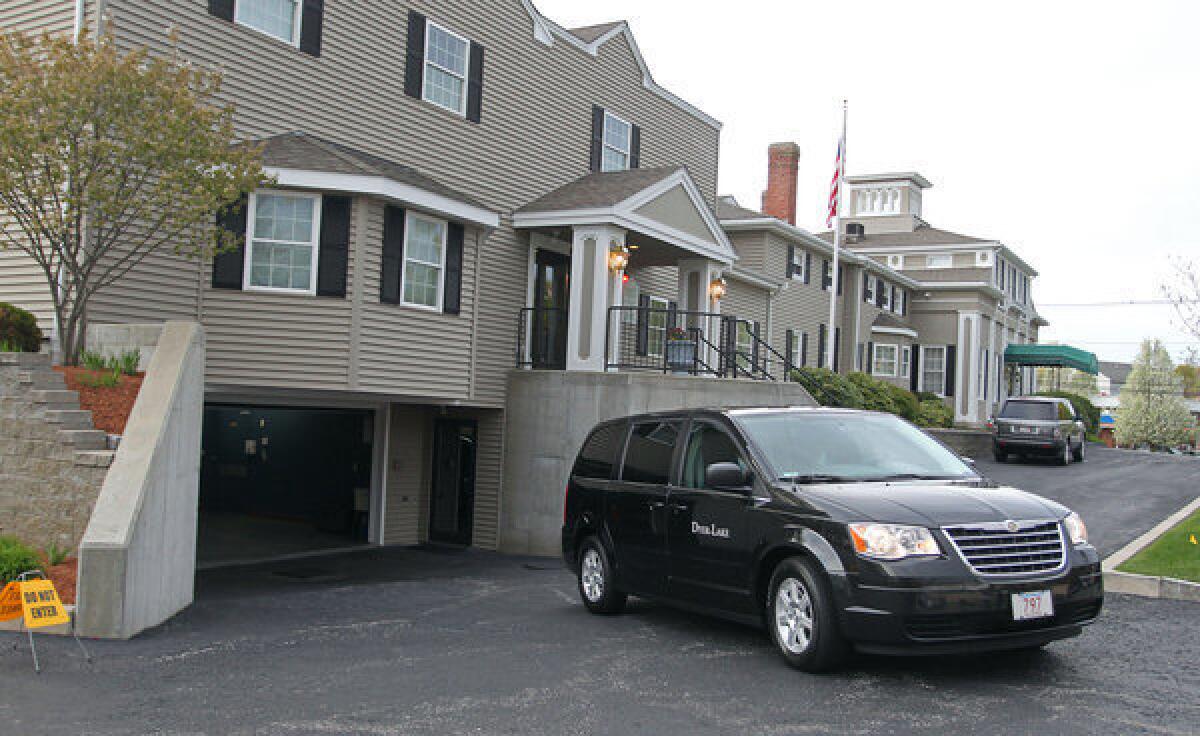 A vehicle believed to be carrying the body of Boston Marathon bombing suspect Tamerlan Tsarnaev backs into an underground garage at the Dyer-Lake Funeral Home in North Attleborough, Mass. The body has been moved to a different funeral home.