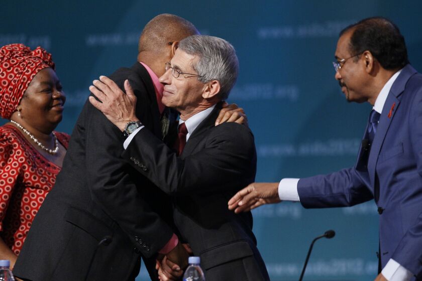 From left, Sheila Tlou, Phill Wilson, Anthony Fauci of the National Institute of Allergy and infectious Diseases, and UNAIDS Executive Director Michel Sidibe, gather on stage after Fauci spoke at the XIX International Aids Conference, Monday, July 23, 2012, in Washington. (AP Photo/Carolyn Kaster)