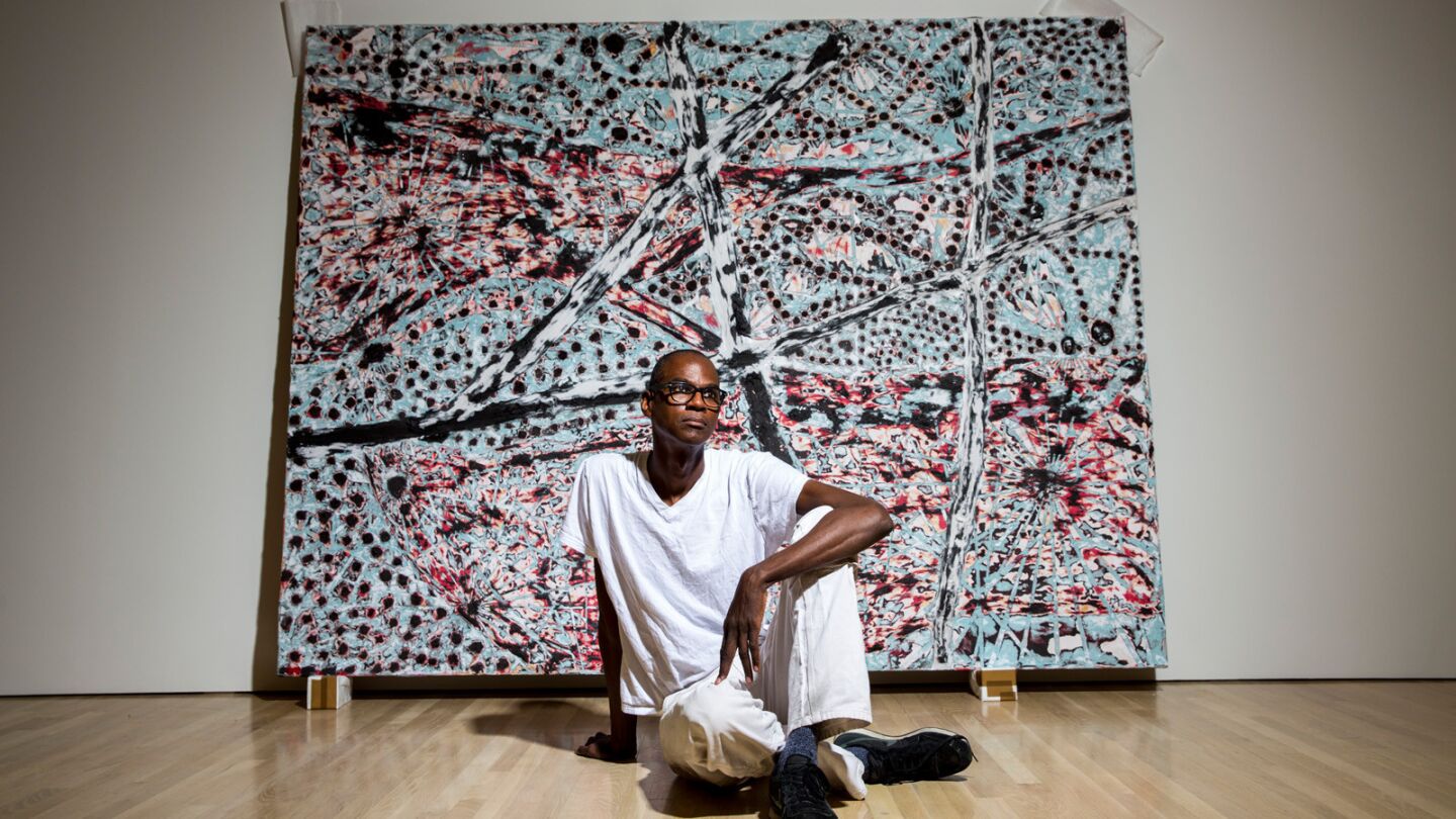 Los Angeles-born artist Mark Bradford is photographed in front of "The Next Hot Line." This piece is part of his show "Scorched Earth," installed at the Hammer Museum in Westwood, June 11, 2015.