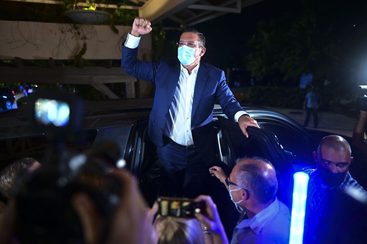 Pedro Pierluisi, gubernatorial candidate with the New Progressive Party (PNP), arrives at Vivo Beach Club to celebrate a slim lead of the pro-statehood party in the Puerto Rican general elections, in Carolina, Puerto Rico, Tuesday, Nov. 3, 2020. Pierluisi briefly served as governor following last year's massive protests that led to the resignation of former Gov. Ricardo Rosselló. (AP Photo/Carlos Giusti)