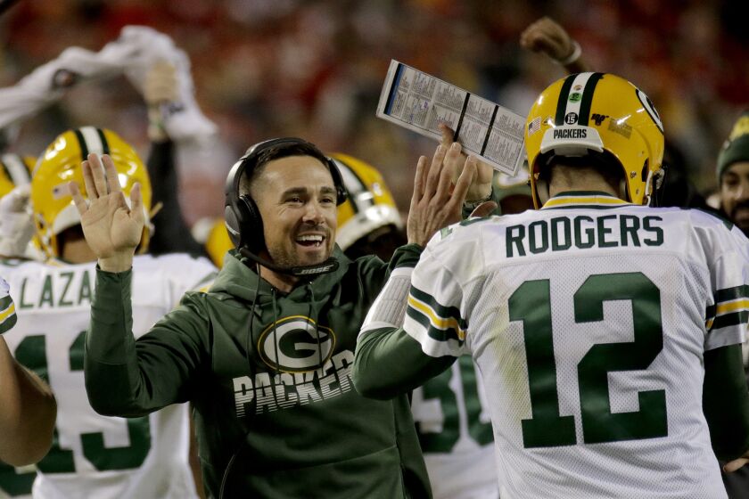 Green Bay Packers head coach Matt LaFleur celebrates with quarterback Aaron Rodgers (12) after a touchdown during the first half of an NFL football game against the Kansas City Chiefs Sunday, Oct. 27, 2019, in Kansas City, Mo. (AP Photo/Charlie Riedel)