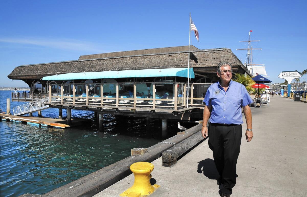 Craig Ghio, chief executive of Anthony's Fish Grotto, walks near the landmark restaurant on San Diego's waterfront. The Port District is debating whether to renew its lease or replace it with one of two other restaurant ventures.