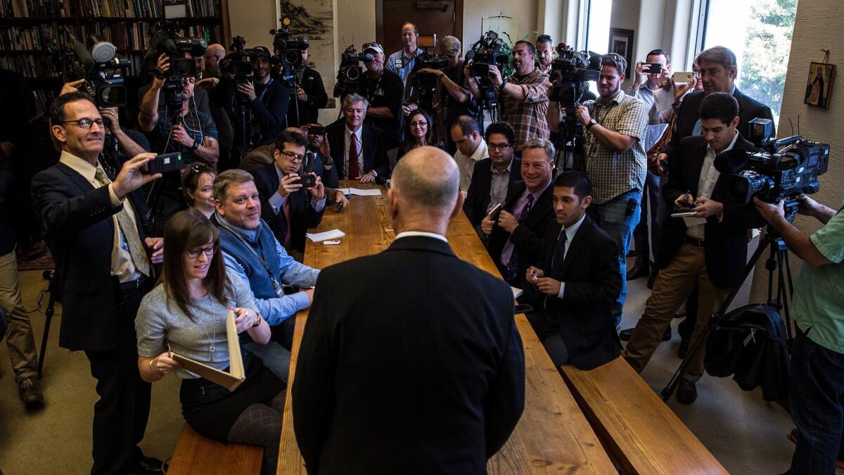 Journalists interview California Gov. Jerry Brown at a press conference in Sacramento. New research shows that even small news outlets have a measurable influence on the public.