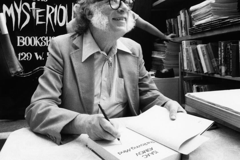 Author Isaac Asimov autographs books at the Mysterious Book Store stall on February 2, 1984 during the Fifth Avenue Book Fair held in New York City, United States. The 64-year-old science fiction writer will publish his 300th book in 1984. (AP Photo/Mario Suriani)