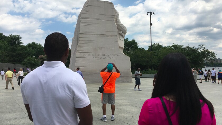 Two FBI trainees study the memorial to Martin Luther King Jr. as part of a class exploring what FBI Director James B. Comey has called the bureau's "shameful" history of investigating the civil rights icon.