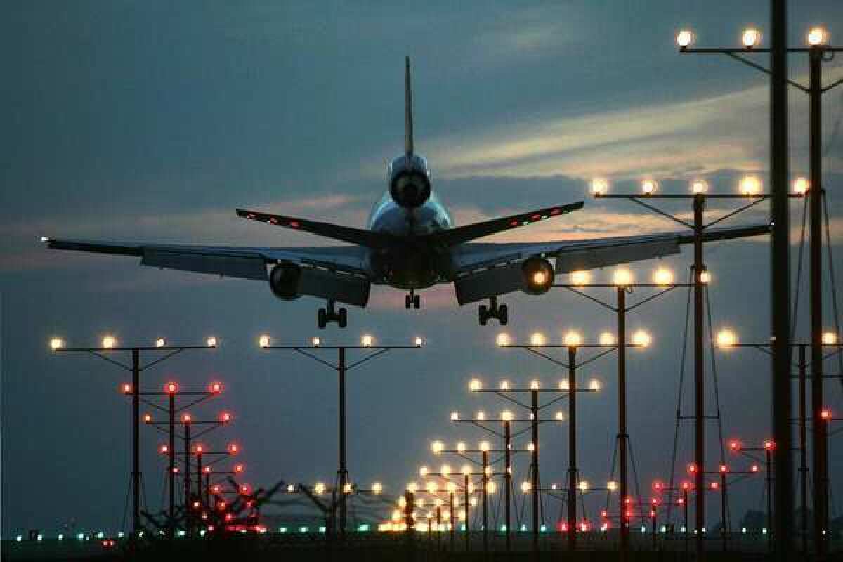 A plane lands at Los Angeles International Airport.