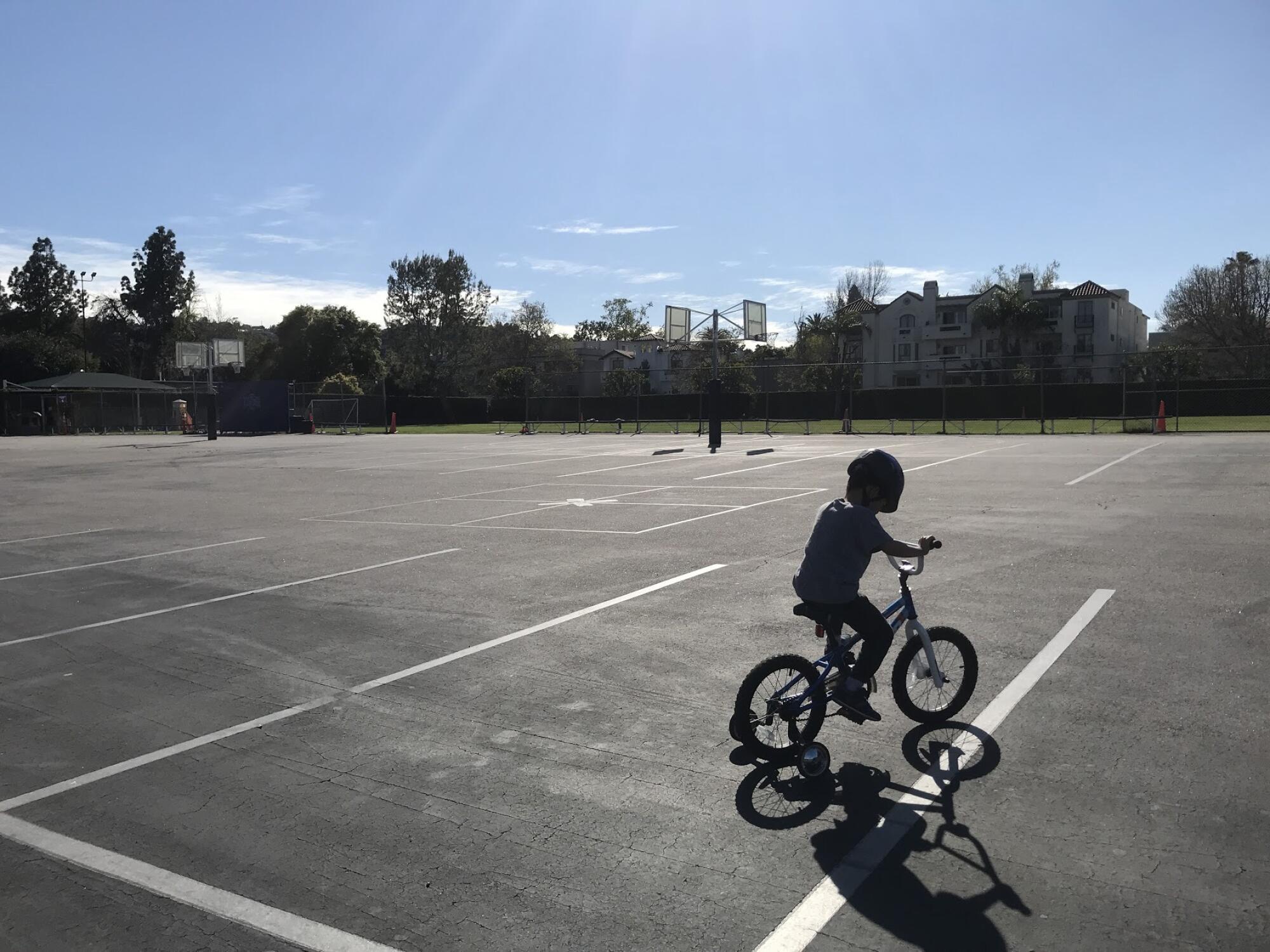  Boy riding his bike in a secluded parking lot