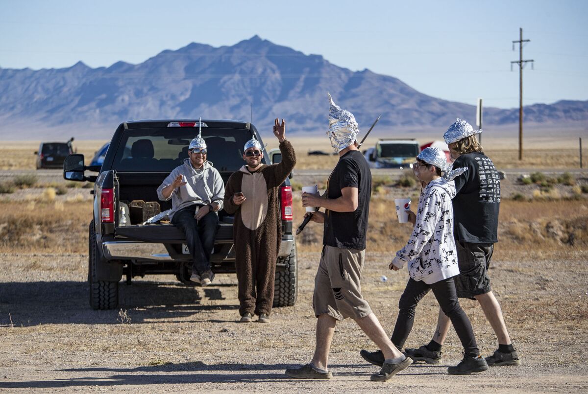 Alien enthusiasts wearing foil hats greet each other near the Little A'Le'Inn in the Area 51 adjacent town of Rachel, NV.