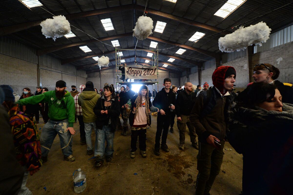 People dance during a party in a disused hangar in Lieuron 
