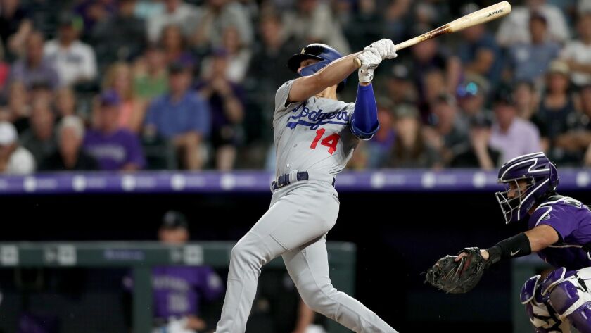 Dodgers' Enrique Hernandez hits a three-run home run in the ninth inning against the Colorado Rockies on Thursday in Denver.