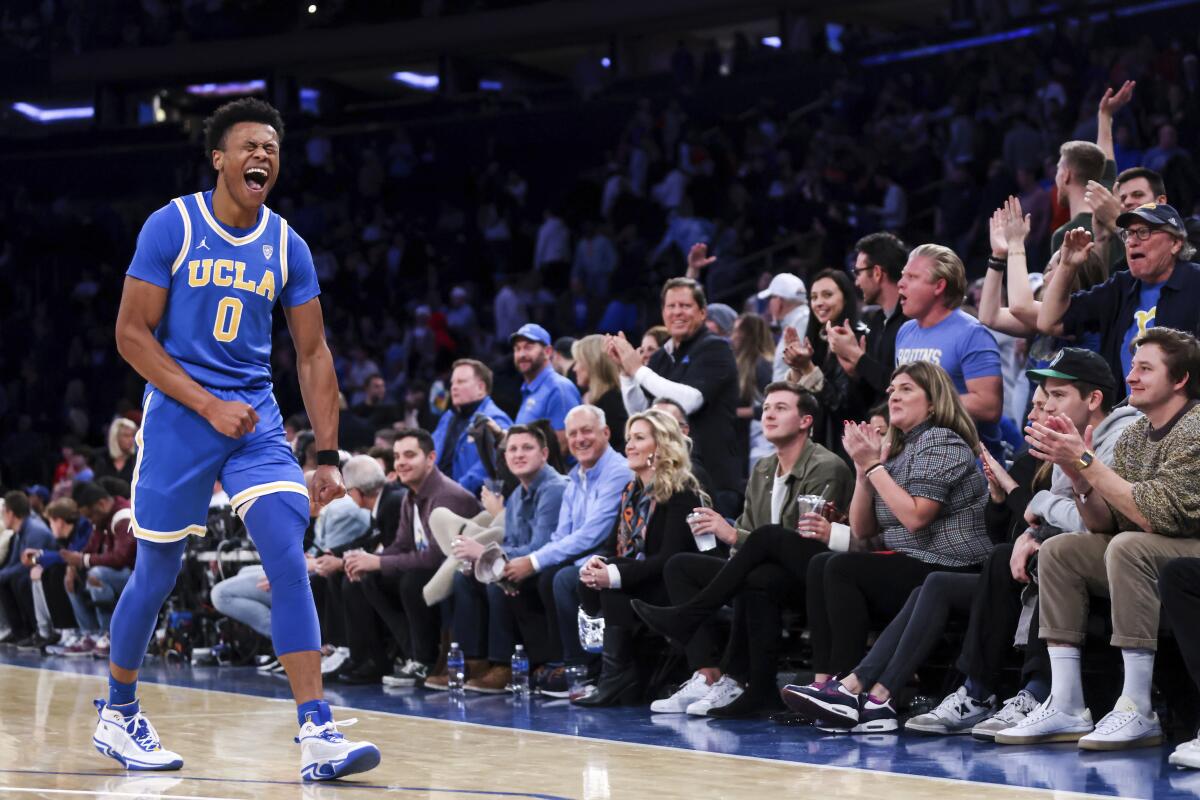 UCLA guard Jaylen Clark yells as he walks across the court.