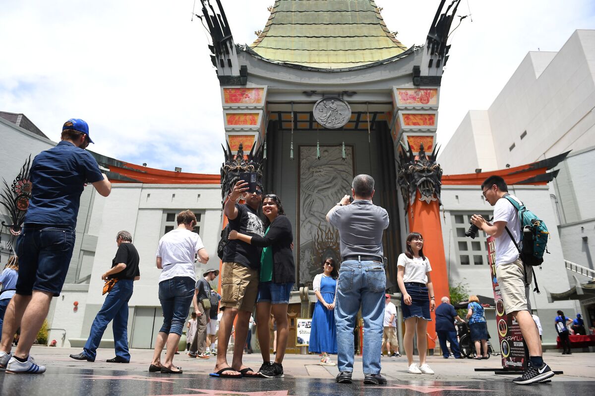 Tourists visit the TCL Chinese Theatre Imax in Hollywood on May 2. (Christina House / For The Times)