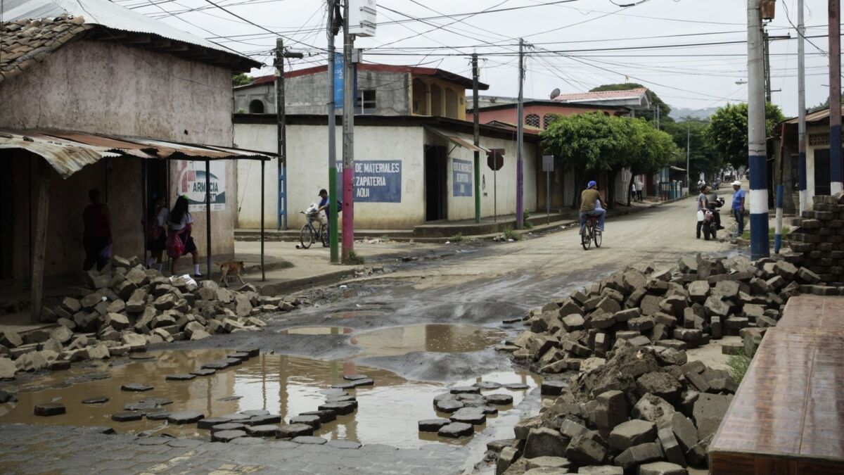 Potholes are left in the streets of Masaya, Nicaragua, after the paving stones were used to assemble anti-government barricades.