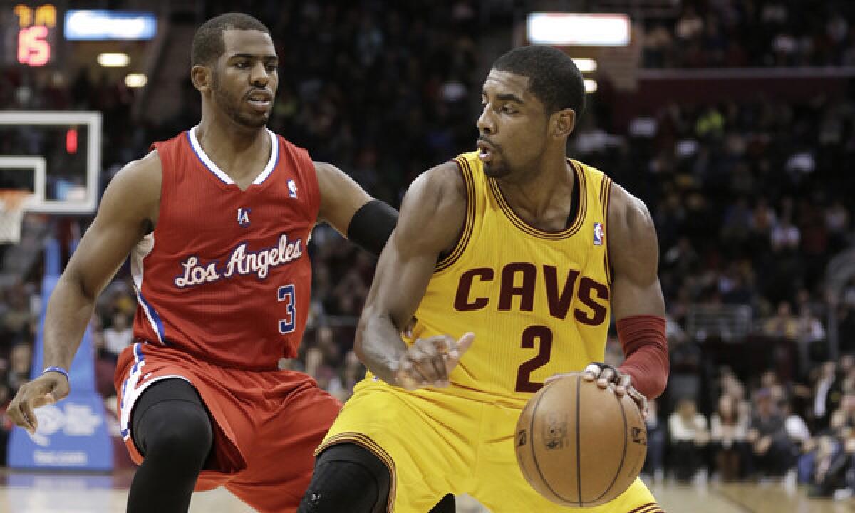 Cleveland's Kyrie Irving, right, tries to drive past Clippers guard Chris Paul during the Cavaliers' 88-82 victory over the Clippers on Saturday.