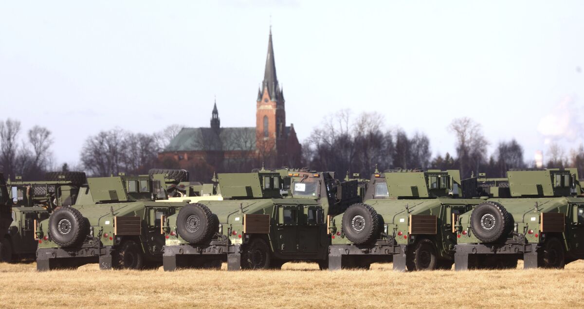 U.S. troops of the 82nd Airborne Division recently deployed to Poland because of the Russia-Ukraine tensions are setting up camp at a military airport in Mielec, southeastern Poland, on Saturday, Feb. 12, 2022. About 4,700 additional U.S. troops are deployed to Poland, were some 4,000 U.S. troops have been stationed since 2017. (AP Photo/Beata Zawrzel)