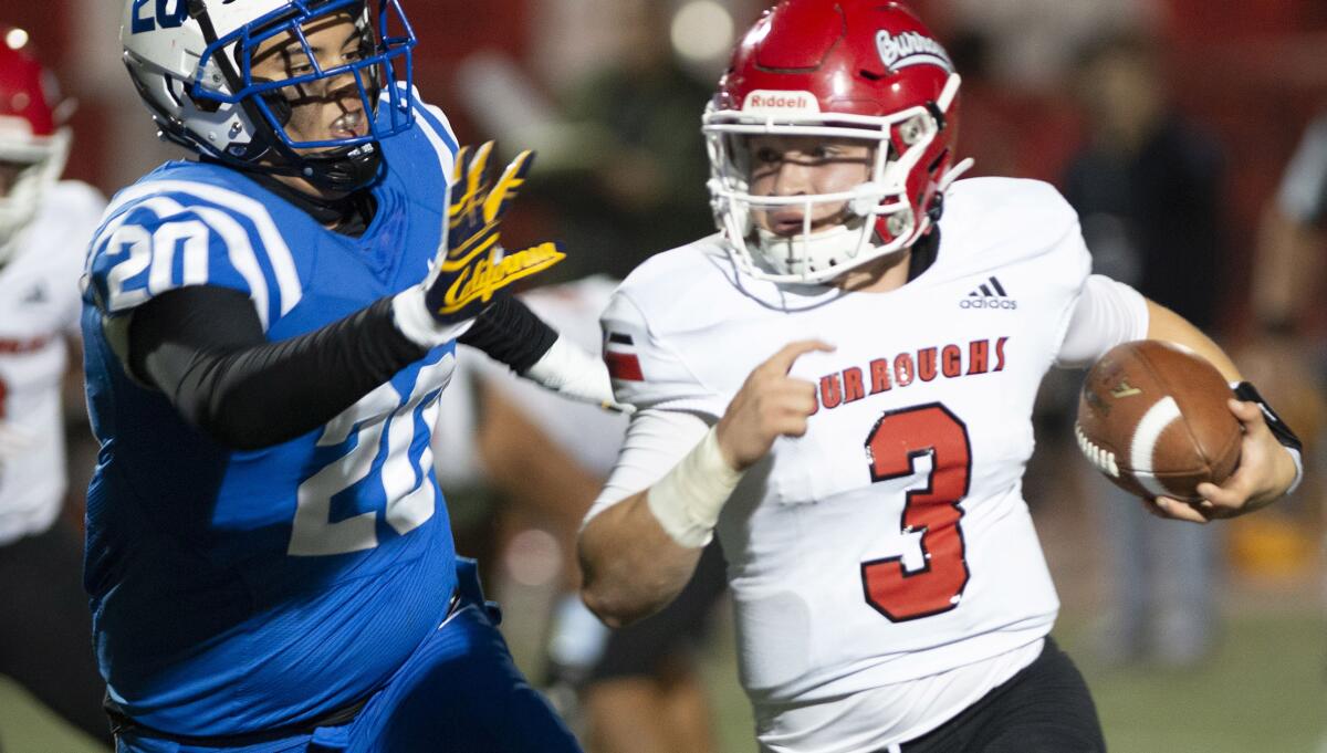 Burroughs High's Garcia tries to outrun Burbank's Austin Blacano on a keeper during Friday's Pacific League game.