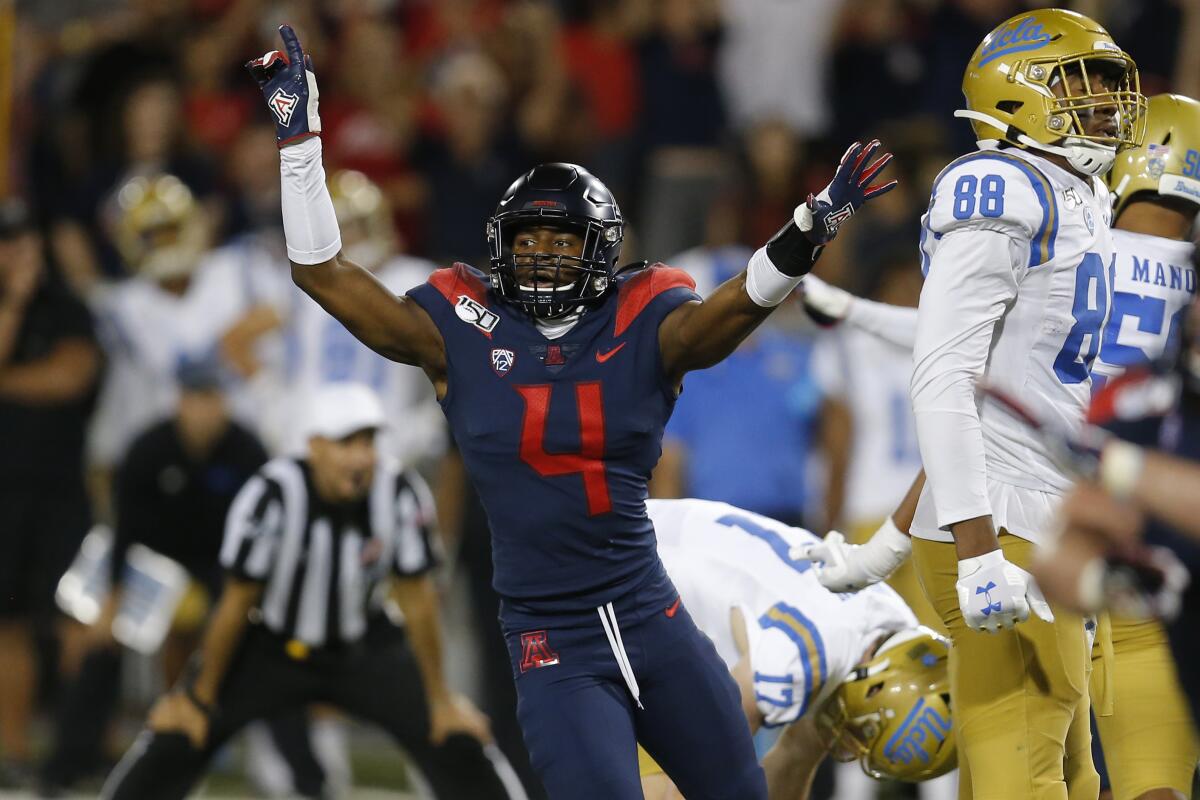Arizona's Christian Roland-Wallace (4) celebrates after UCLA kicker J.J. Molson (17) missed a potential game-tying field goal late.
