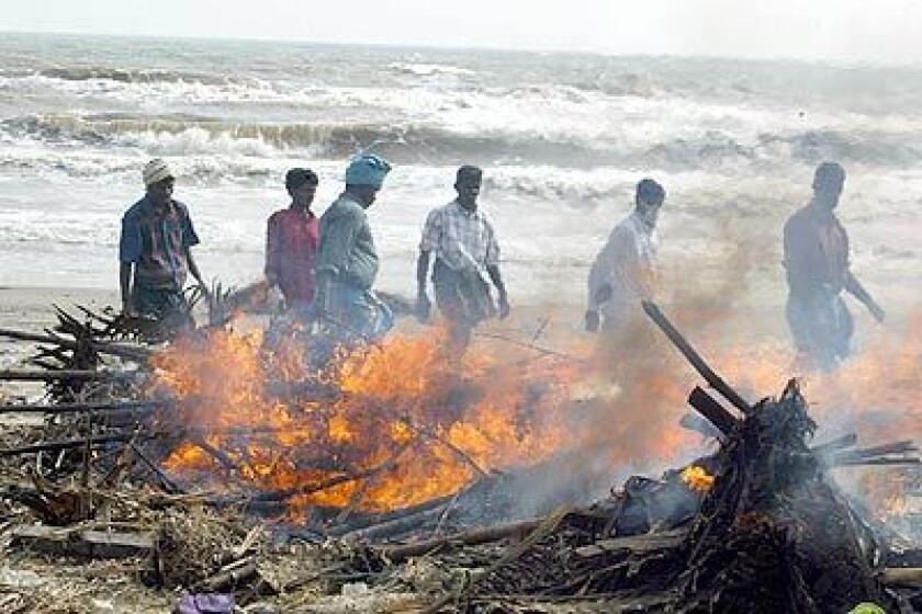 LOST LIVES: The bodies of tsunami victims are cremated amid seaside debris in Nagappattinam, on Indias southeastern coast.