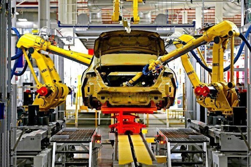 FILE - In this March 14, 2014 file photo, automated robots build a 2015 Chrysler 200 at the Sterling Heights Assembly Plant in Sterling Heights, Mich. Whatâ€™s happened in the auto industry reveals a lot about how the economy has been transformed _ and why a nearly normal 5.6 percent unemployment isnâ€™t pushing up wages. (AP Photo/Paul Sancya, File)