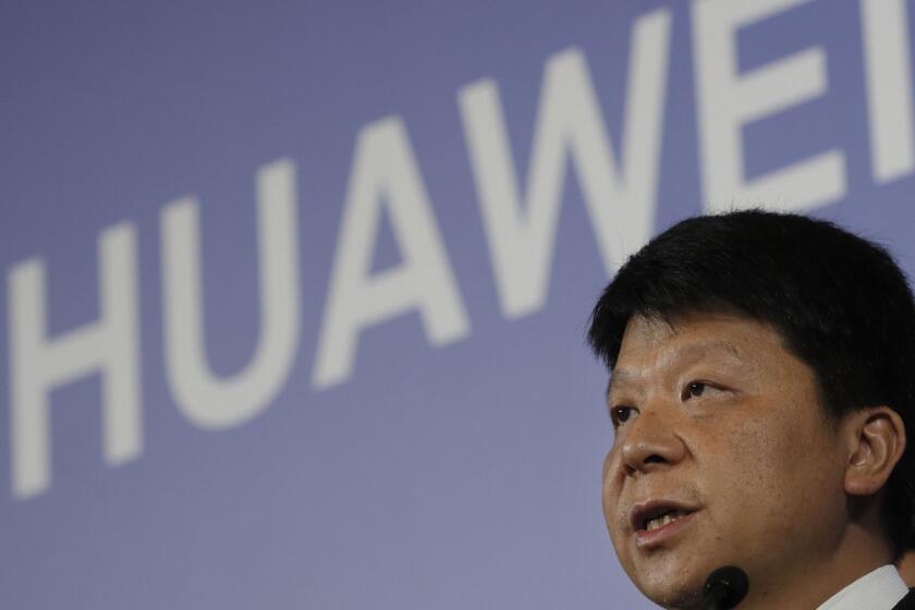 Huawei Rotating Chairman Guo Ping, center, speaks during a press conference in Shenzhen city, China's Guangdong province, Thursday, March 7, 2019. Chinese tech giant Huawei is launching a U.S. court challenge to a law that labels the company a security risk and would limit its access to the American market for telecom equipment. (AP Photo/Kin Cheung)