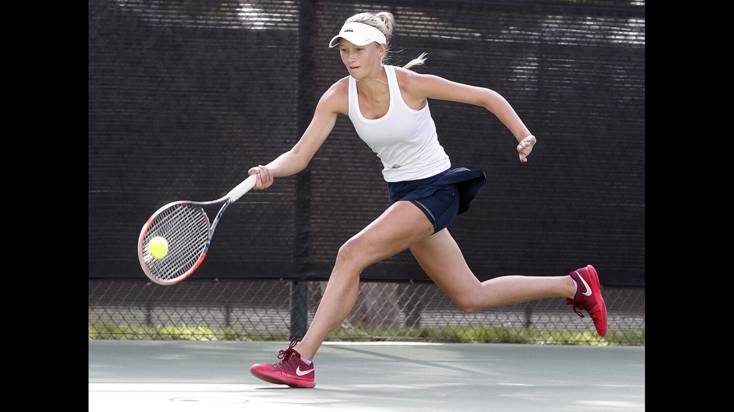 Corona Del Mar's Danielle Willson chases a wide shot down for a return in a singles match against rival University in the CIF girls' tennis Division I championship at The Claremont Club in Claremont on Friday, November 10, 2017. Corona Del Mar won the championship.