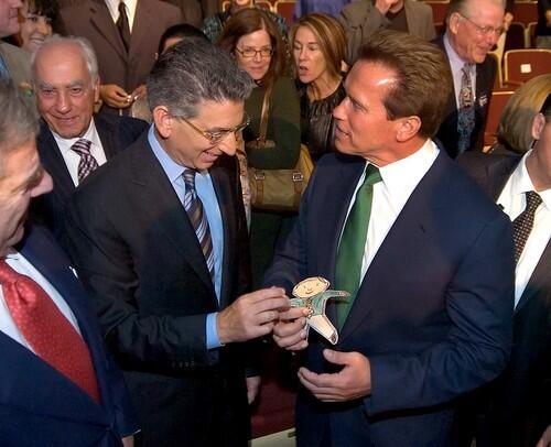 California Gov. Arnold Schwarzenegger, right, and California State Treasurer Phil Angelides talk following a debate in Sacramento. In their hands is Flat Stanley, which belongs to the Governor's son, Christopher.