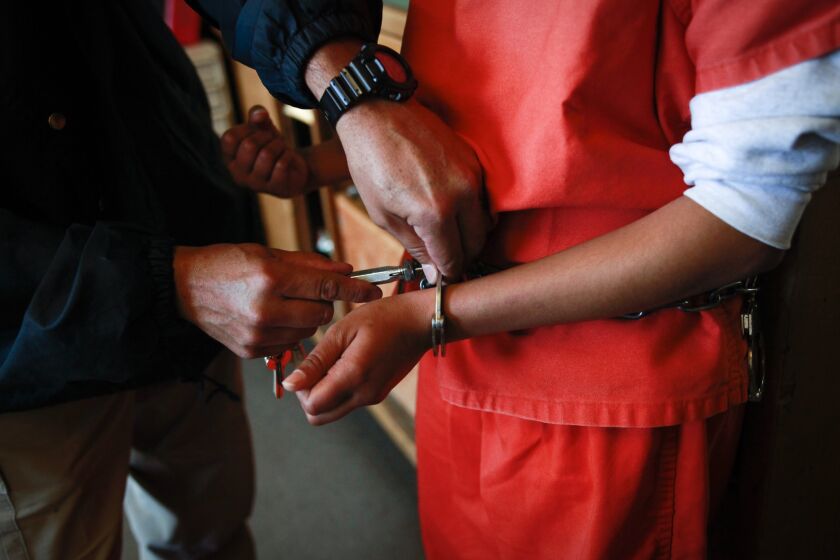 Santa Clarita, CA February 27, 2013: A new arrival at Camp Kenyon Scudder has her handcuffs removed after arriving at the girls detention center. The camp is implementing a new health screening program that is trying to address the problems females might face coming into LA County's juvenile justice system and flag girls who might need any additional help. (Bethany Mollenkof/Los Angeles Times)