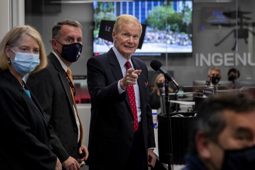 PASADENA CA - OCTOBER 14, 2021: NASA Administrator Bill Nelson, right, takes questions after speaking to the team at the Mars 2020 Perseverance Rover Mission Operations area on October 14, 2021at JPL in Pasadena, California. NASA Deputy Administrator Pam Melroy, left, and Bobby Braun, Director for Planetary Science, JPL, is in the middle.(Gina Ferazzi / Los Angeles Times)