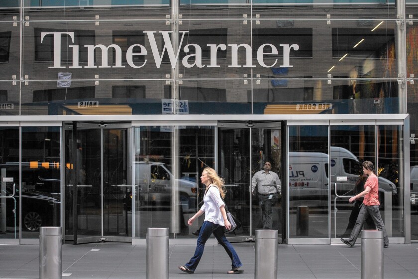 People walk past the entrance to the Time Warner Center in New York on Aug. 7, 2013.